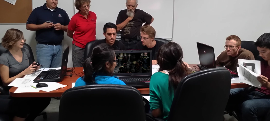 A training cohort works on an assessment activity while experts supervise